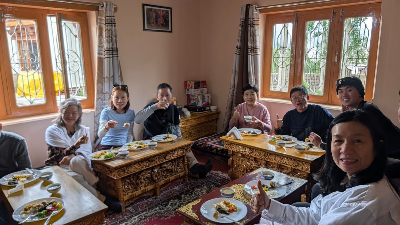 A group of guests enjoying a Ladakhi meal together