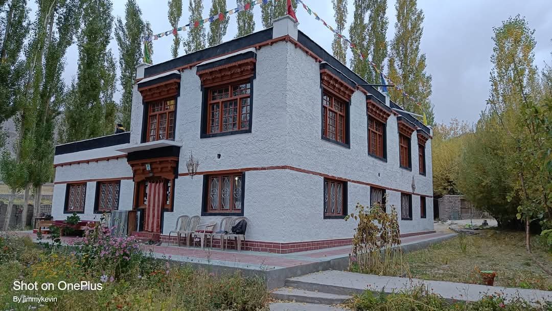 The family home, with whitewashed walls and red-framed Ladakhi windows